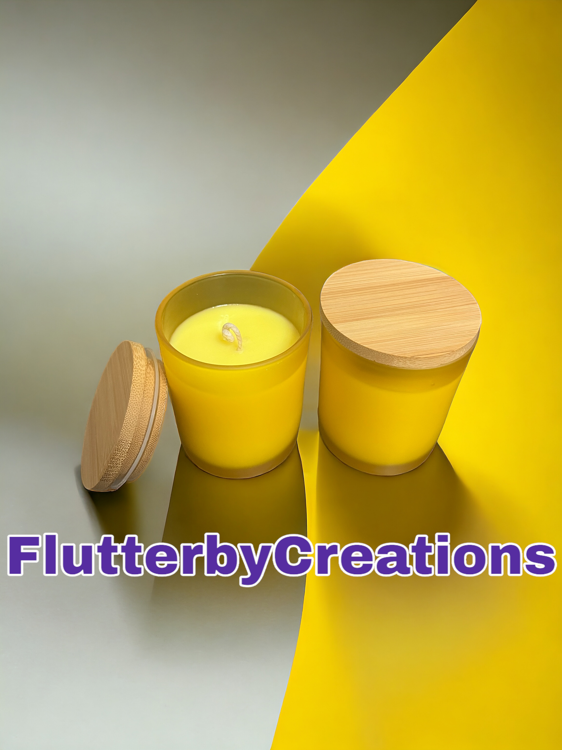 a yellow candle sitting next to a wooden container